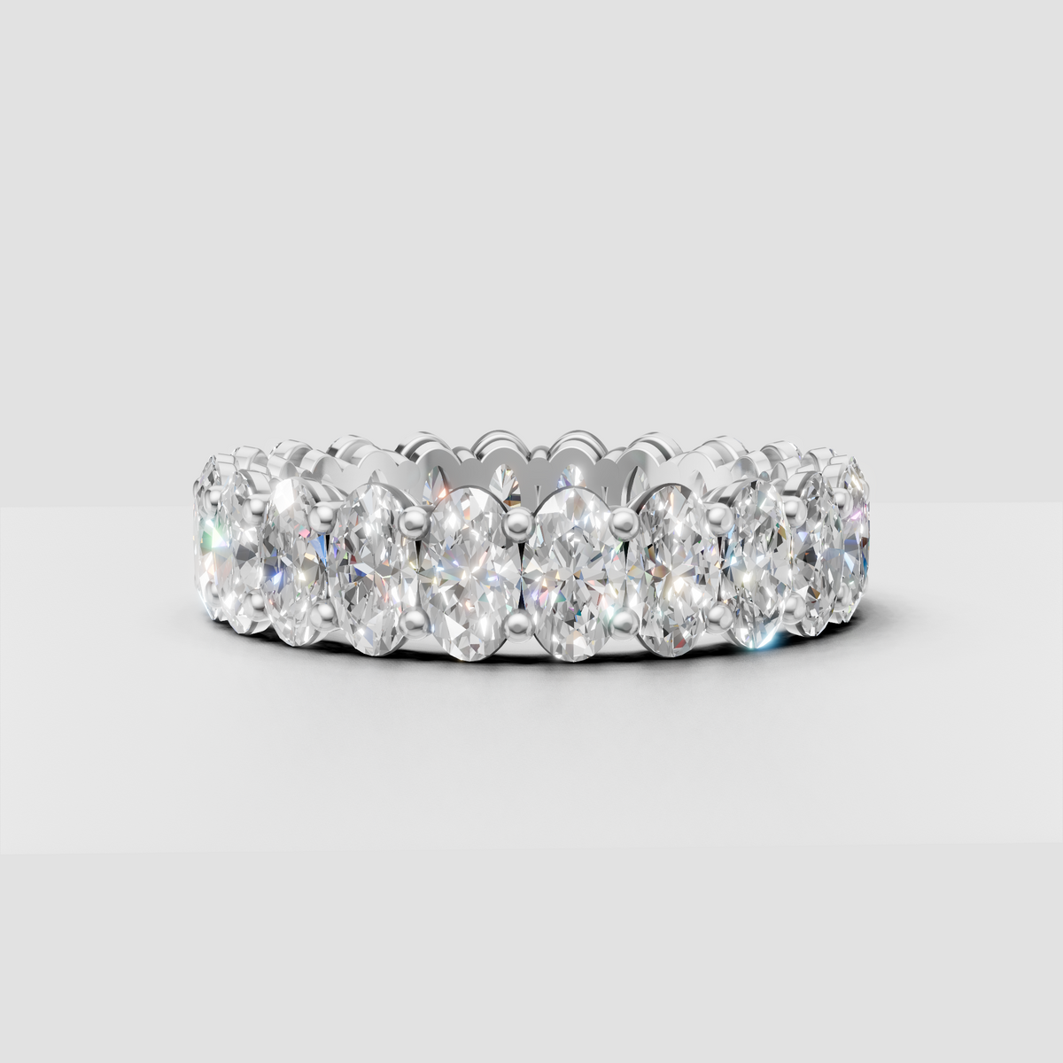 Elongated oval diamond eternity band with gold prongs