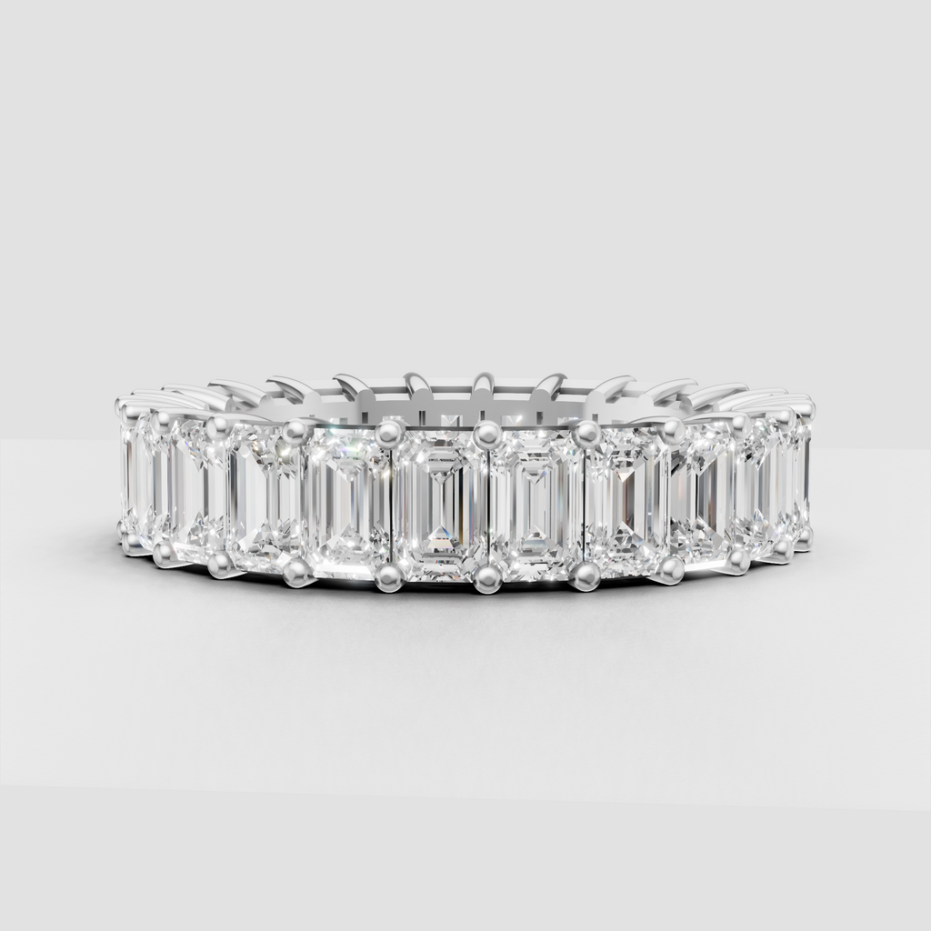 Yellow gold emerald cut diamond eternity ring with prongs