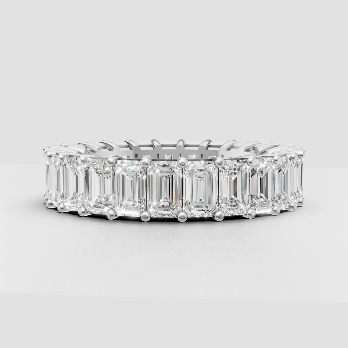 Yellow gold emerald cut diamond eternity ring with prongs