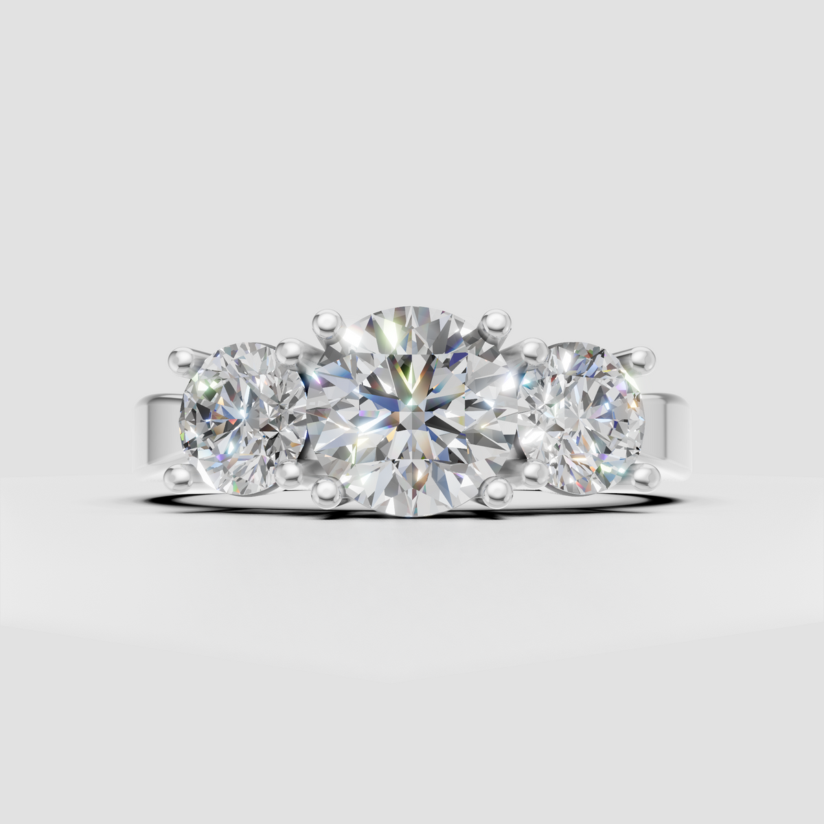 Classic three-stone engagement ring with round center diamond