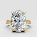 Oval diamond engagement ring with pear and round diamond accents in yellow gold