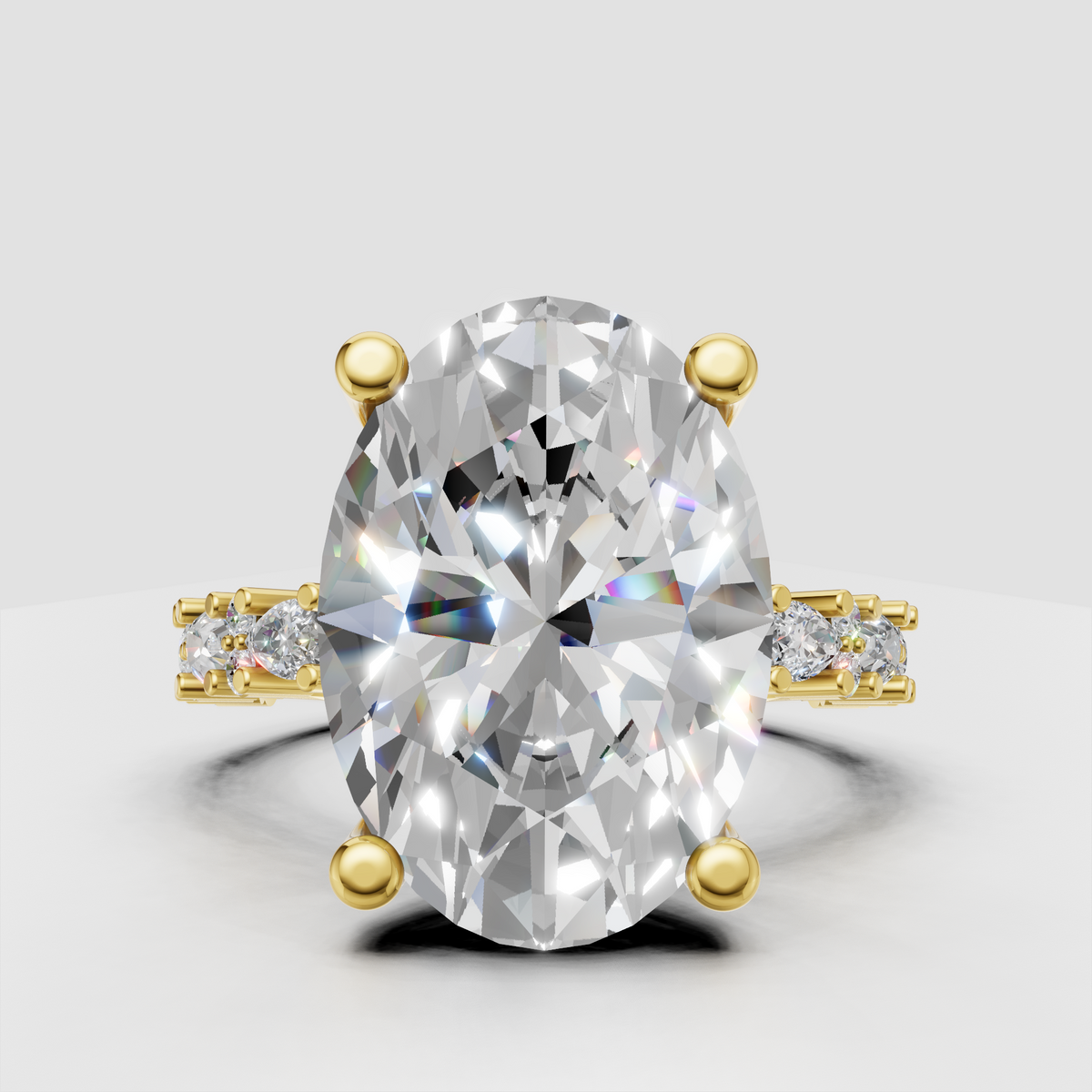 Oval diamond engagement ring with pear and round diamond accents in yellow gold