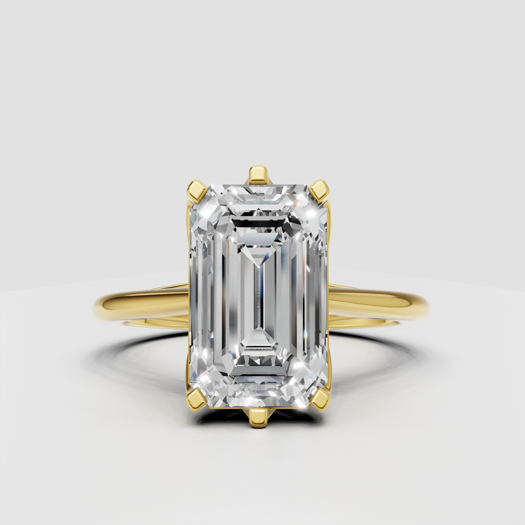 Emerald cut diamond solitaire engagement ring in polished yellow gold