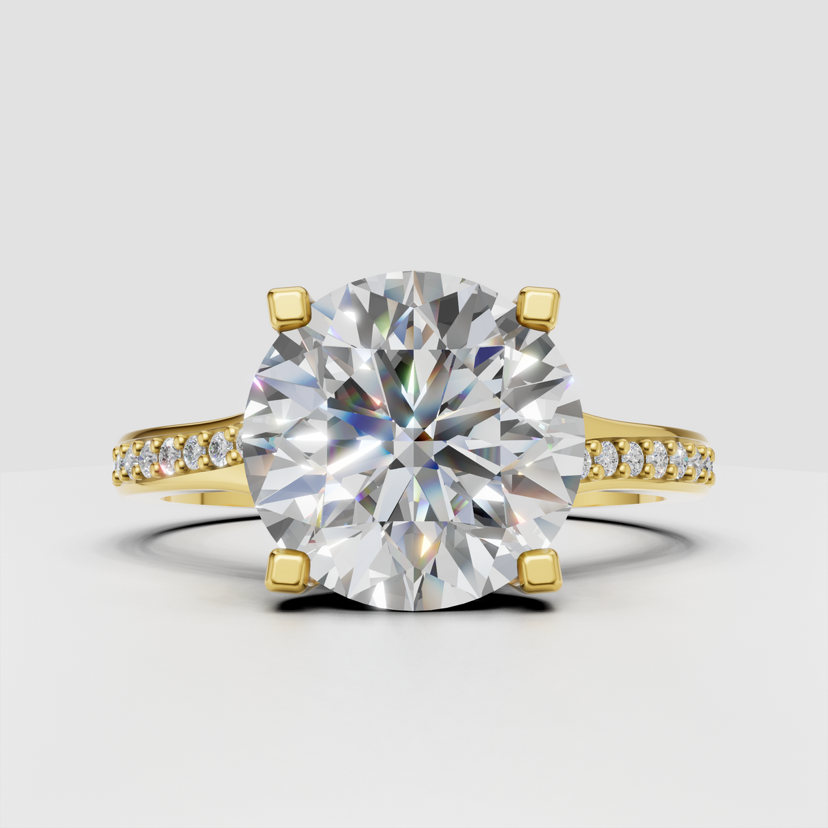Round diamond cathedral engagement ring with pavé yellow gold band