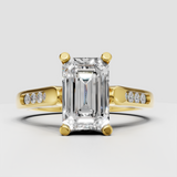 Emerald cut diamond solitaire engagement ring in polished yellow gold.