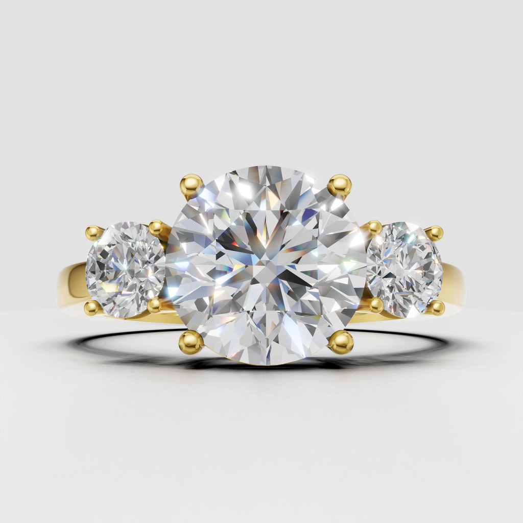 Round diamond three stone ring in polished yellow gold