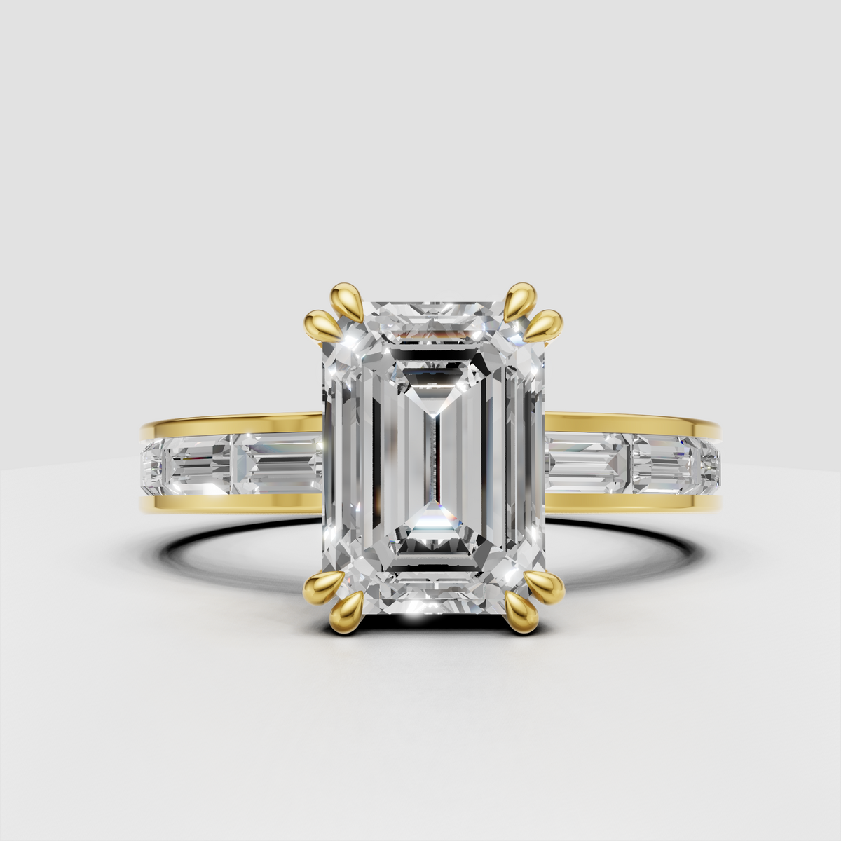Emerald cut diamond engagement ring with baguette side stones in yellow gold