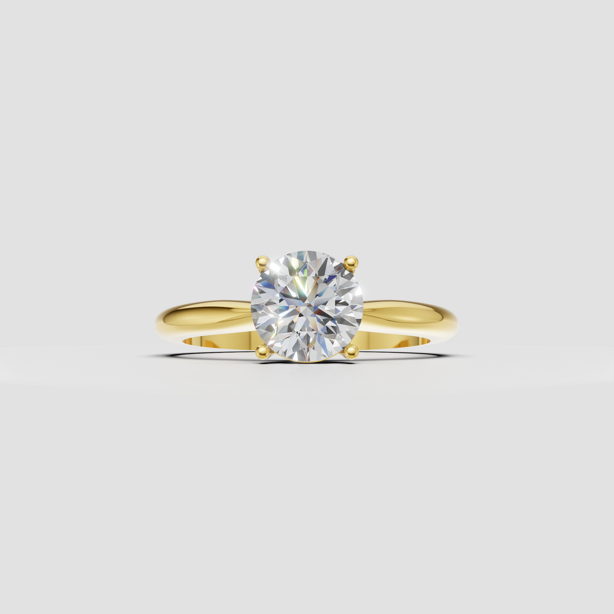 Round cut diamond solitaire ring with four prong setting and polished yellow gold band