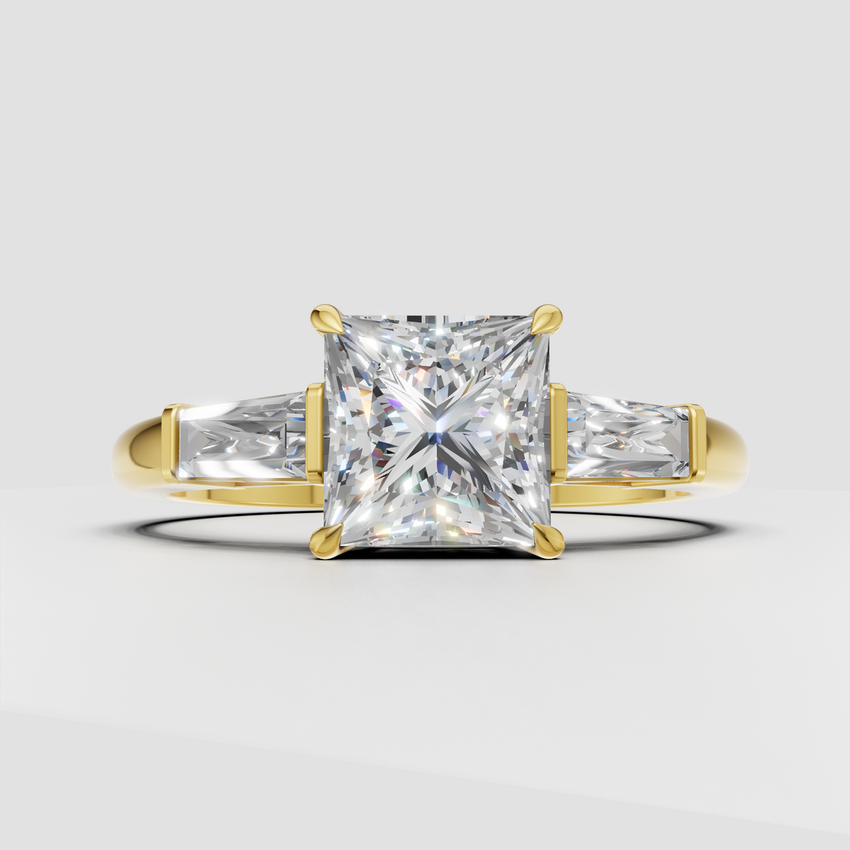 Princess cut diamond three stone engagement ring with baguette side stones in yellow gold
