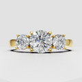 Round Diamond three-stone engagement ring in polished yellow gold