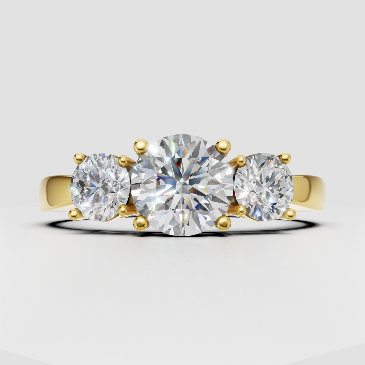Round Diamond three-stone engagement ring in polished yellow gold