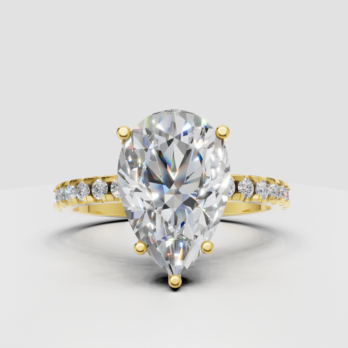 Pear-shaped Diamond four-prong pavé solitaire engagement ring in polished yellow gold