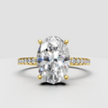 Oval diamond cathedral pavé engagement ring in polished yellow gold