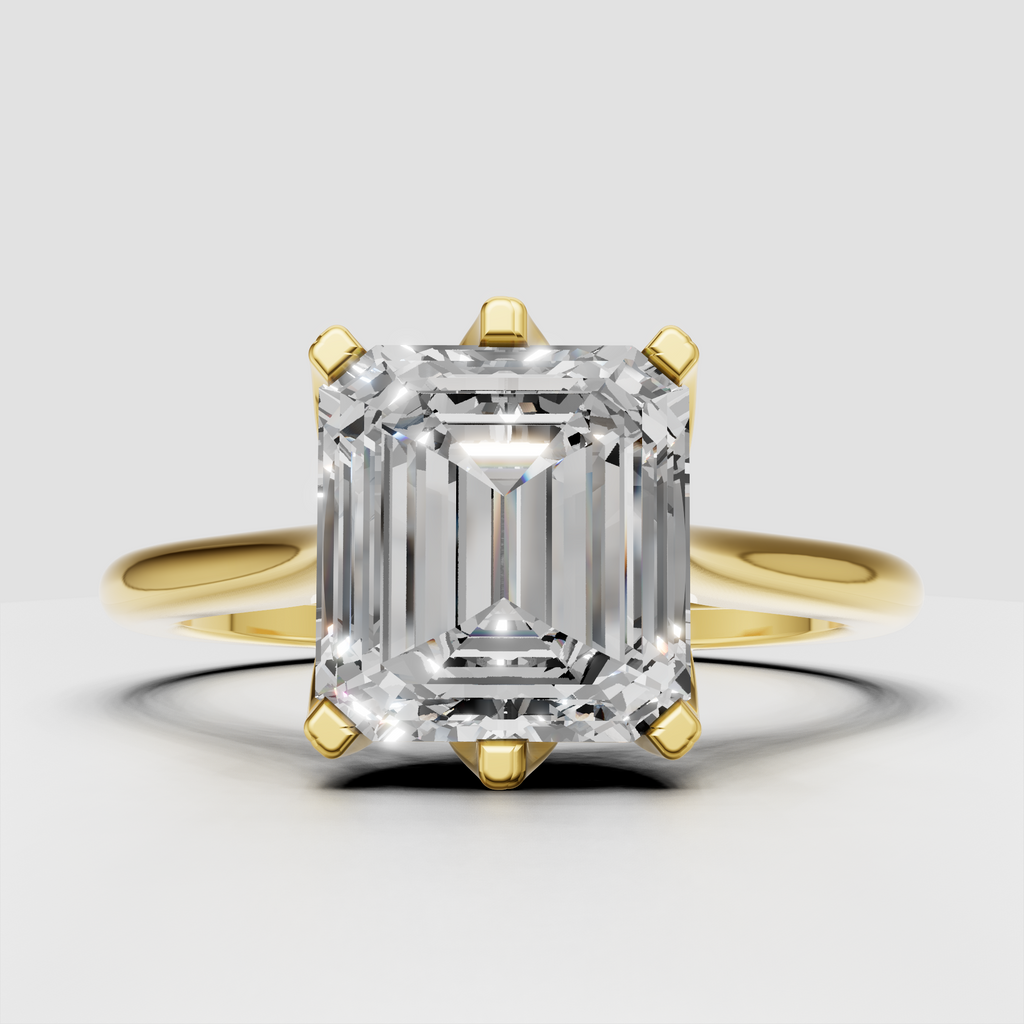 Emerald cut diamond engagement ring with polished yellow gold split shank
