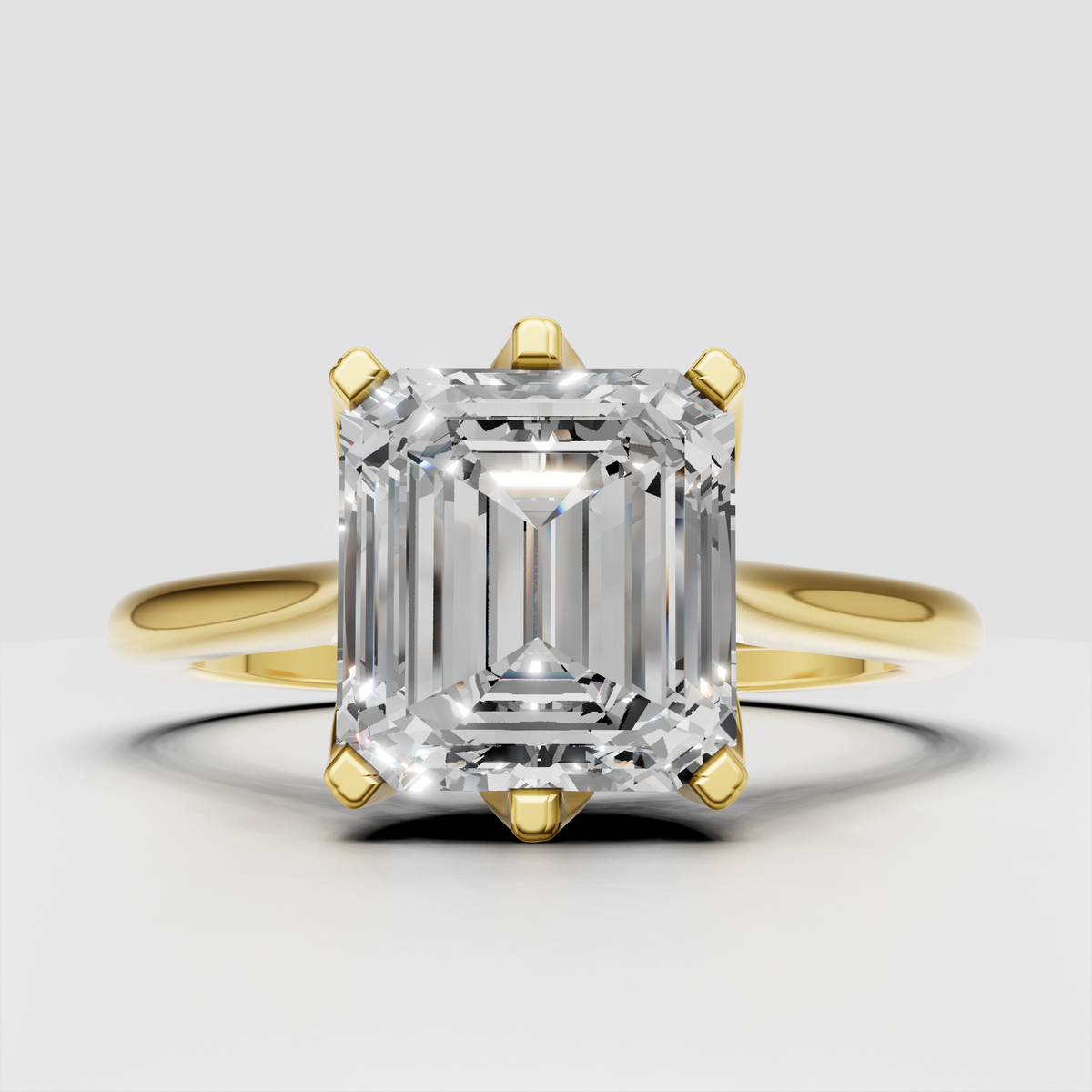 Emerald cut diamond engagement ring with polished yellow gold split shank