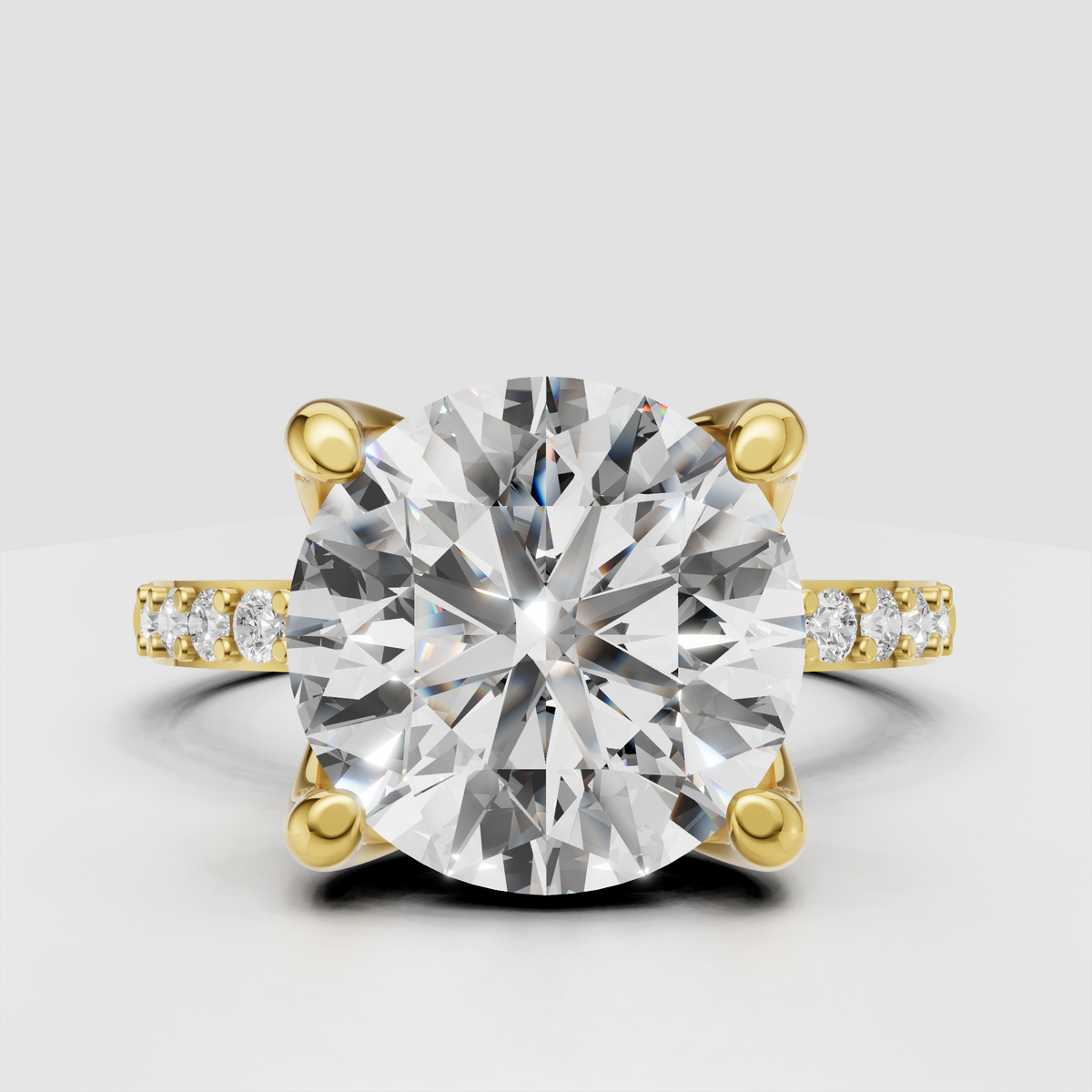 Round brilliant Diamond four-prong pavé cathedral engagement ring in yellow gold
