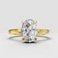 Oval diamond hidden halo engagement ring in polished yellow gold