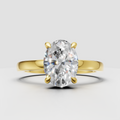 Oval diamond hidden halo engagement ring in polished yellow gold