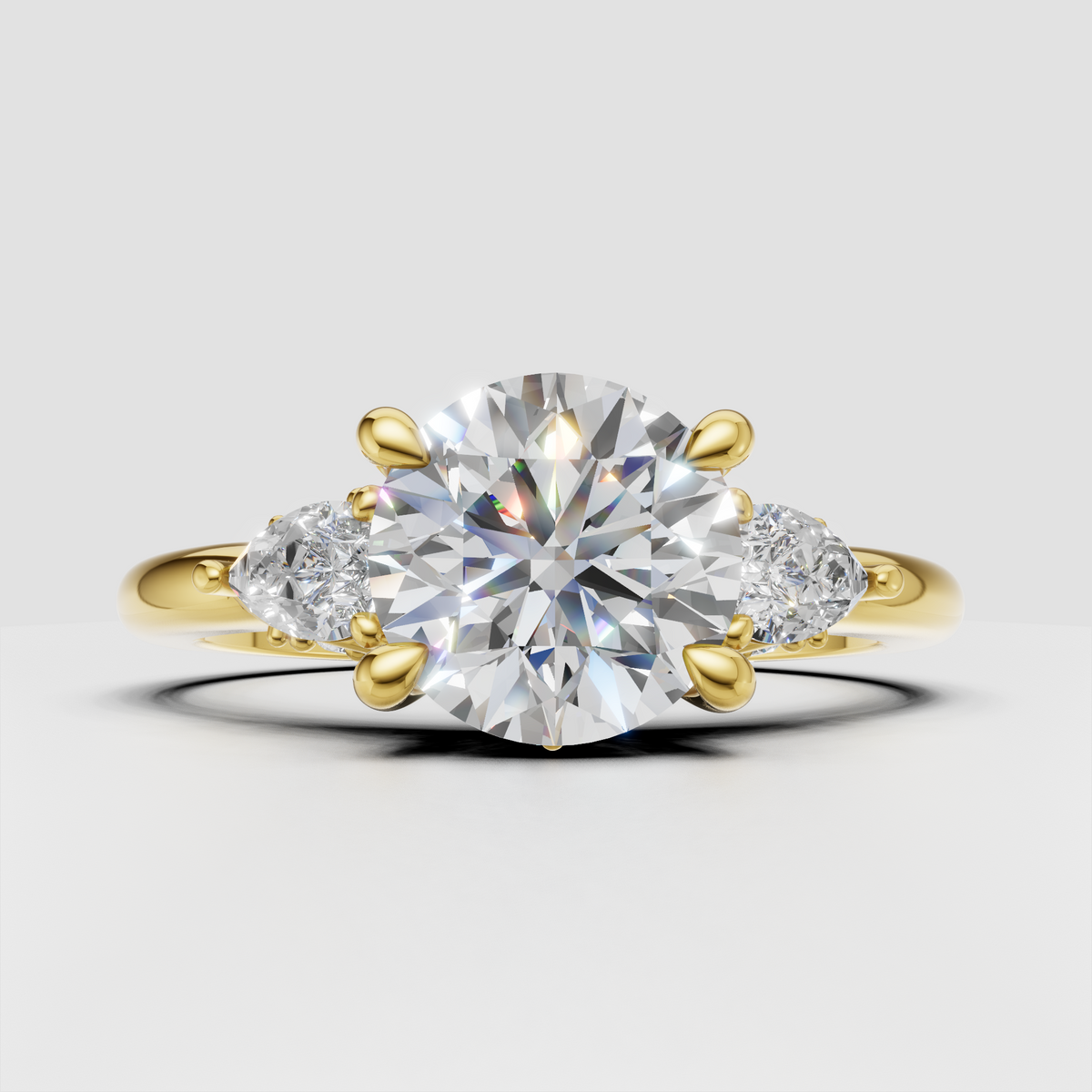 Round diamond three stone floral prong setting engagement ring in yellow gold
