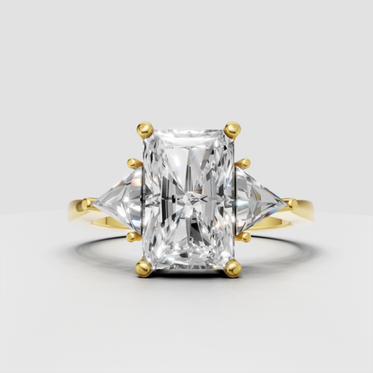 Radiant diamond three-stone engagement ring with trillion side stones in yellow gold