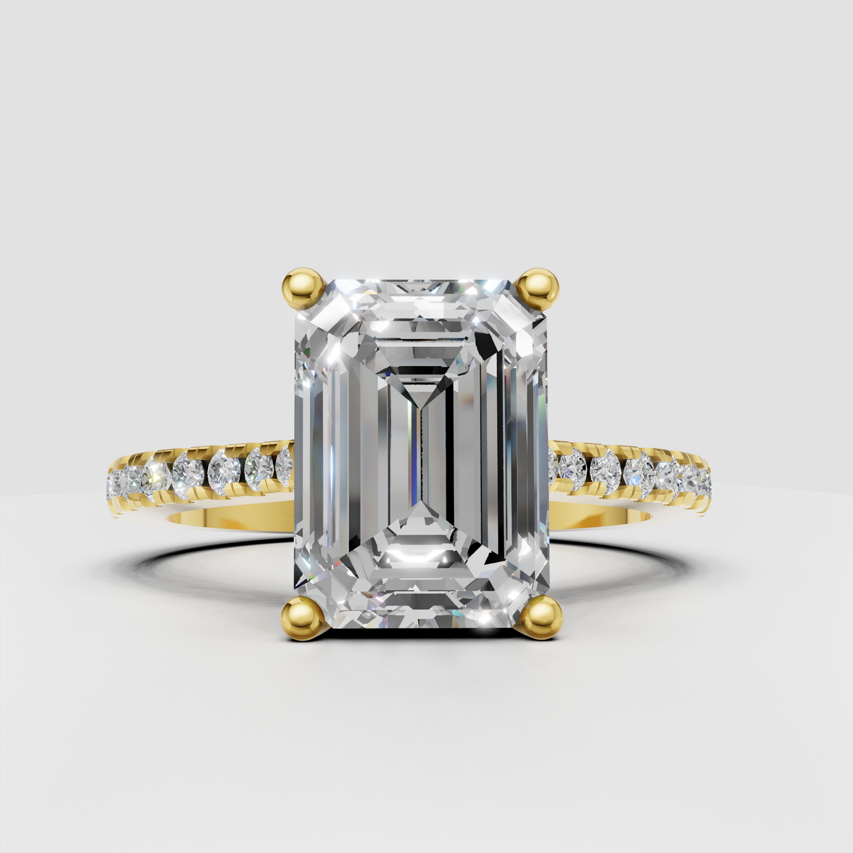 Emerald cut diamond pavé engagement ring in polished yellow gold