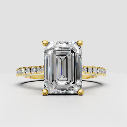 Emerald cut diamond pavé engagement ring in polished yellow gold
