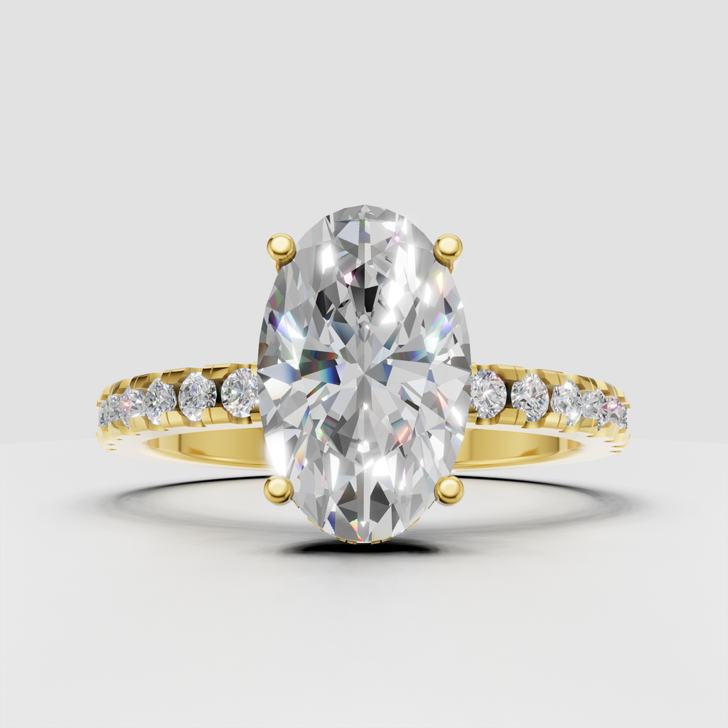 Pear cut diamond cathedral engagement ring in polished yellow gold with pavé band