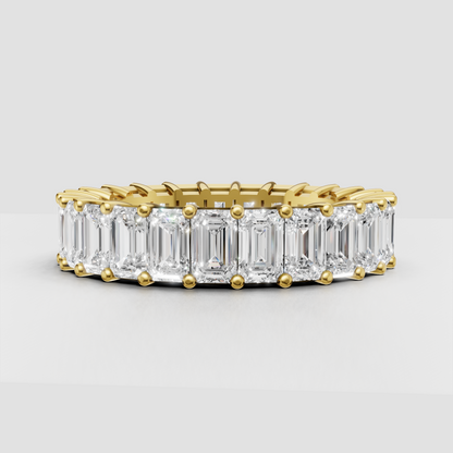 Emerald cut diamond eternity band in polished yellow gold