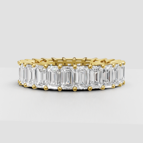 Emerald cut diamond eternity band in polished yellow gold