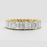 Emerald cut diamond eternity band in polished yellow gold
