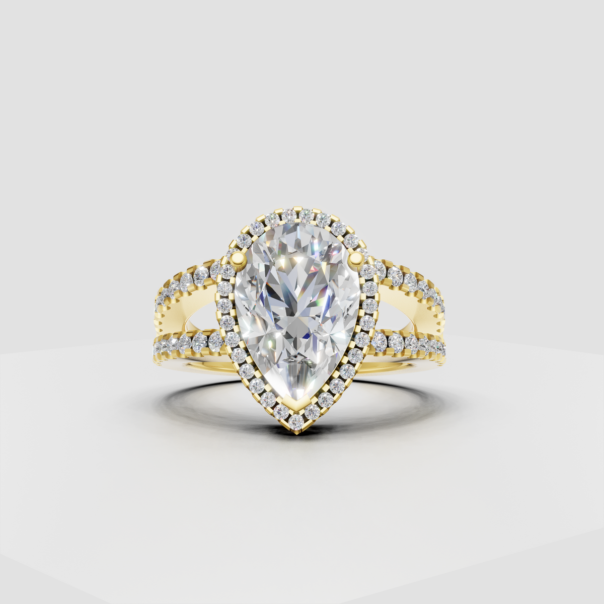 Pear cut diamond halo engagement ring with split-shank pavé band
