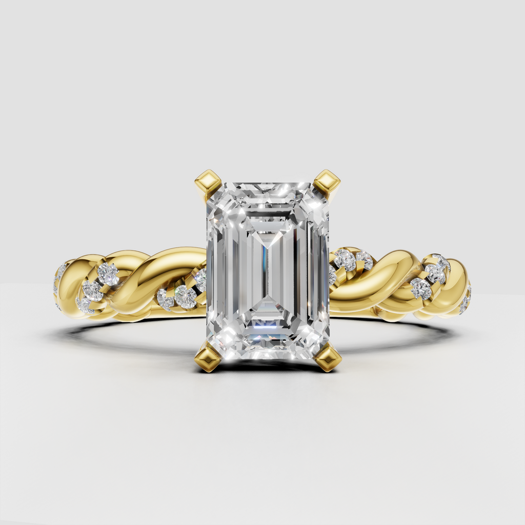 Emerald cut diamond engagement ring with twisted band in yellow gold