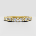 Round and pear cut diamond wedding band in polished yellow gold