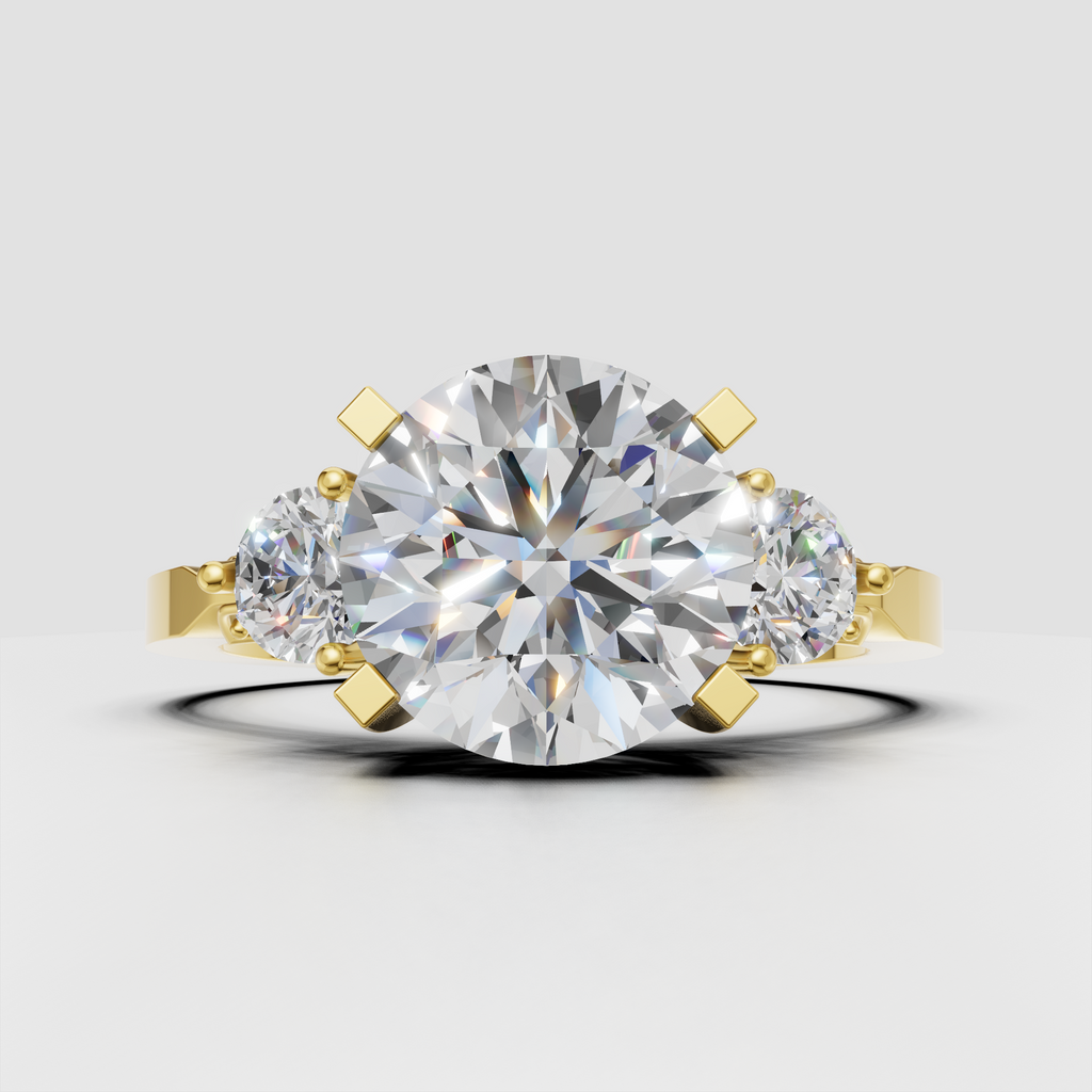 Round diamond three-stone engagement ring in polished yellow gold