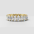 Oval diamond shared prong eternity ring in polished yellow gold