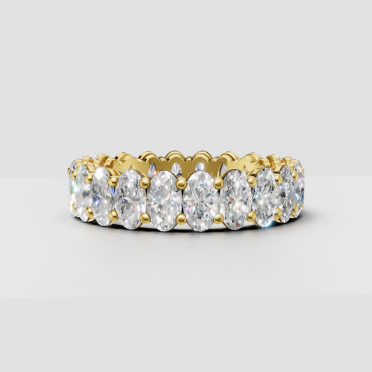 Oval diamond shared prong eternity ring in polished yellow gold