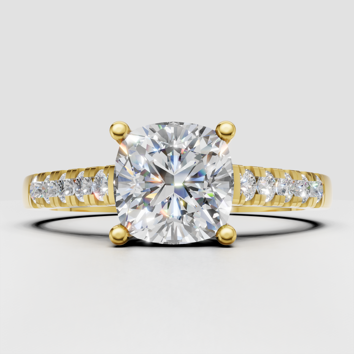 Cushion cut diamond four-prong pavé solitaire engagement ring in yellow gold