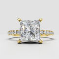Princess cut diamond solitaire ring with four prong setting and yellow gold band
