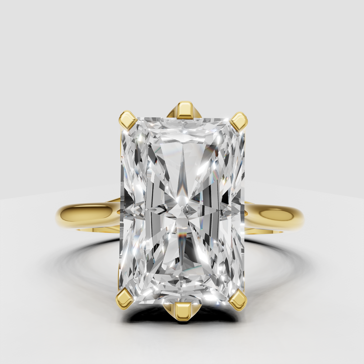 Radiant diamond cathedral prong setting engagement ring in polished yellow gold