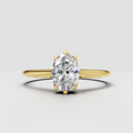 Oval diamond six-prong cathedral solitaire engagement ring in yellow gold