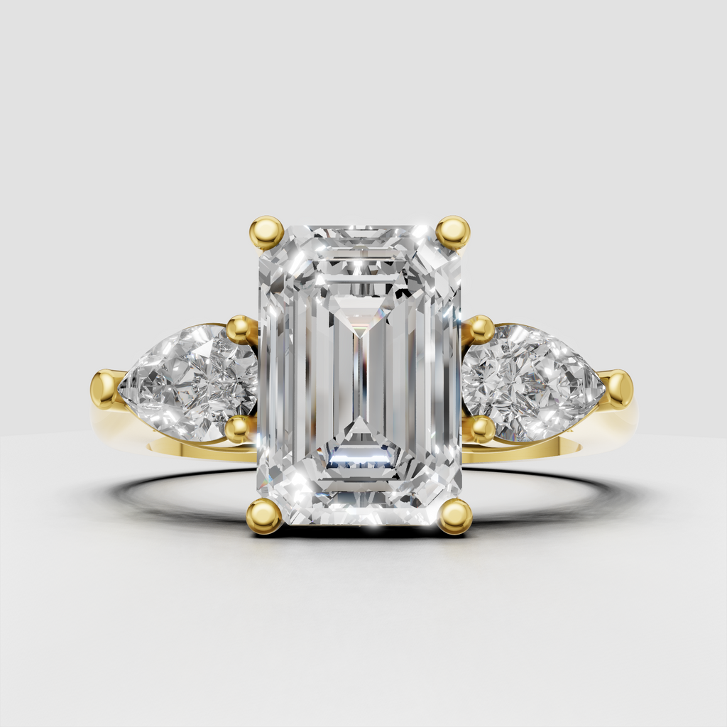 Emerald cut diamond three stone ring in yellow gold