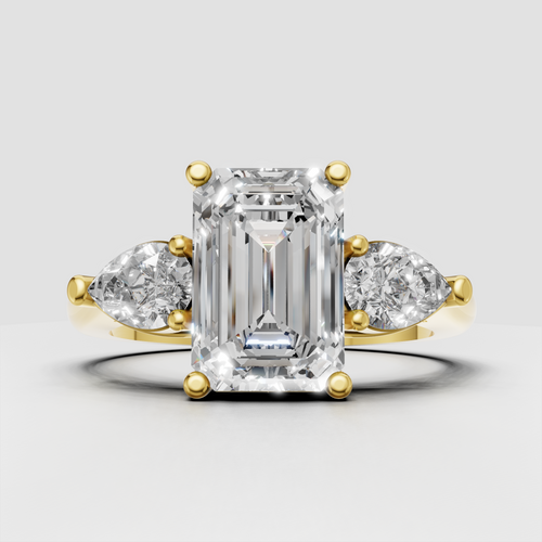 Emerald cut diamond three stone ring in yellow gold