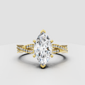 Marquise cut diamond cathedral engagement ring with six-prong setting and pavé split shank band.