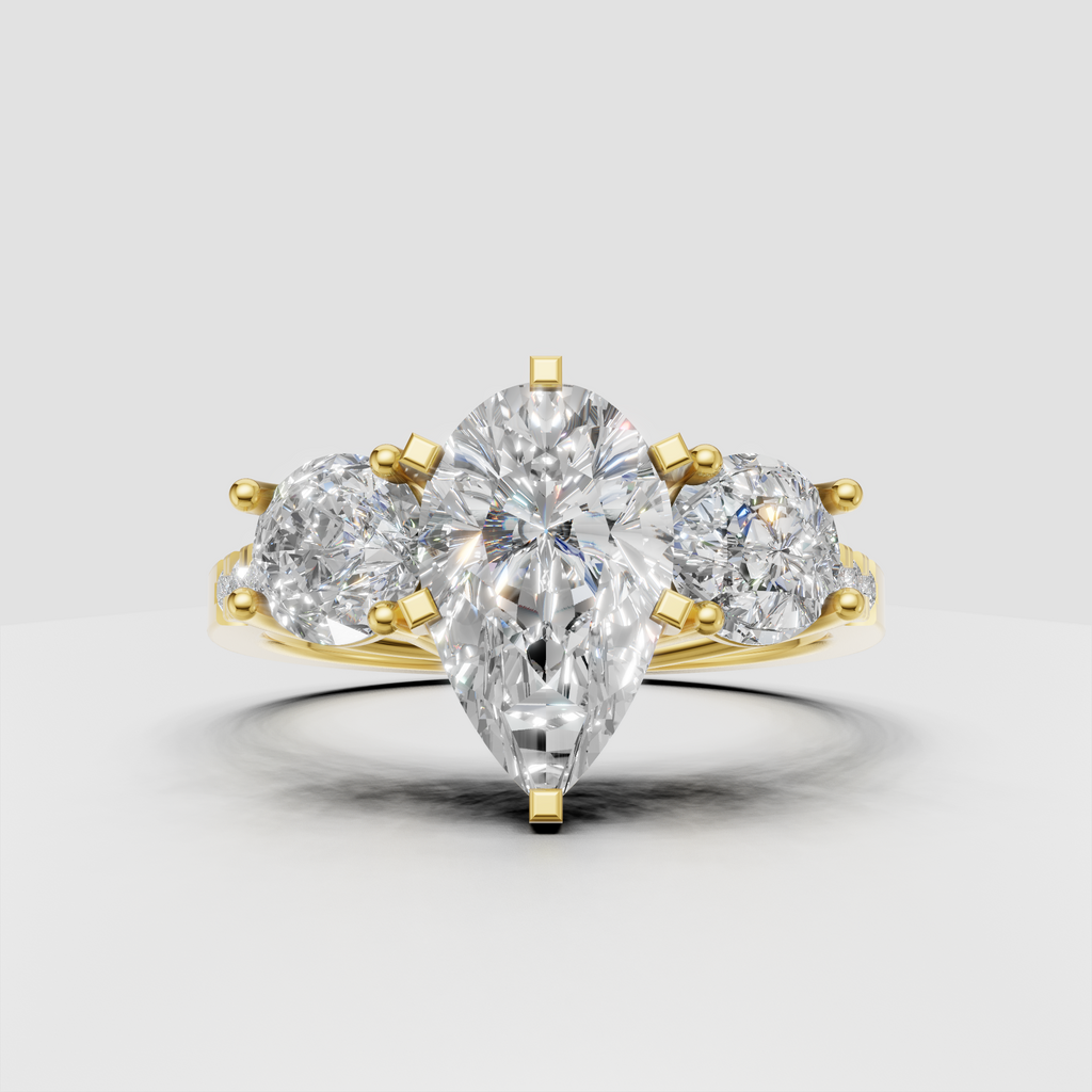 Pear shape diamond three stone yellow gold engagement ring with round side stones