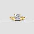 Cushion cut diamond solitaire ring in polished yellow gold