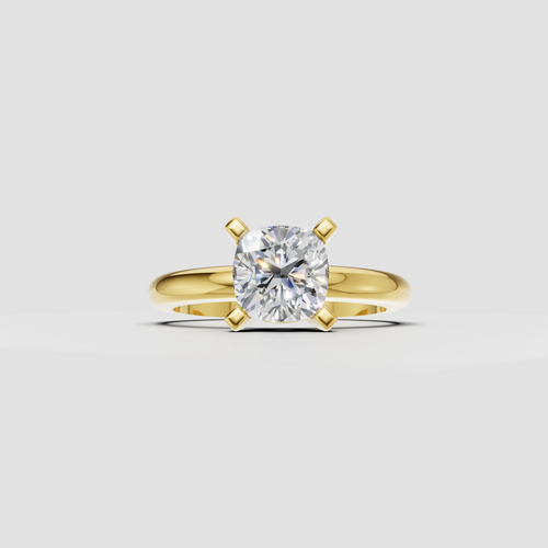 Cushion cut diamond solitaire ring in polished yellow gold