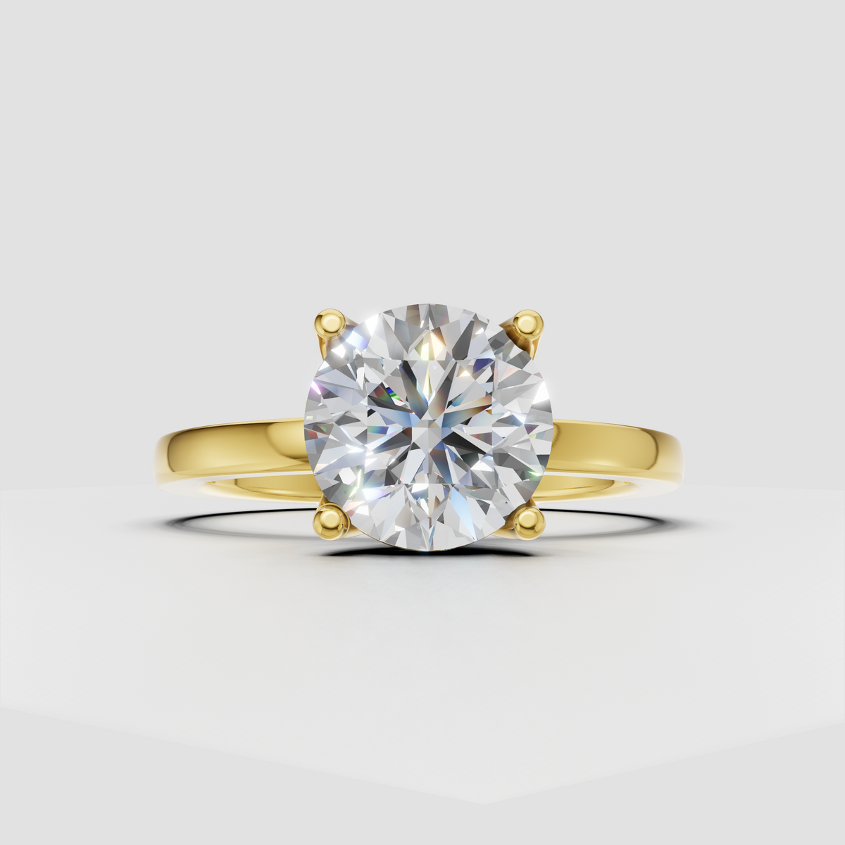 Round cut diamond solitaire engagement ring with four prongs