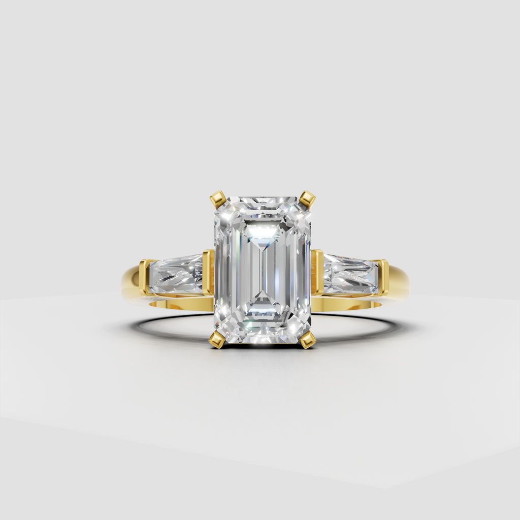 Yellow gold emerald cut engagement ring with tapered baguette side stones