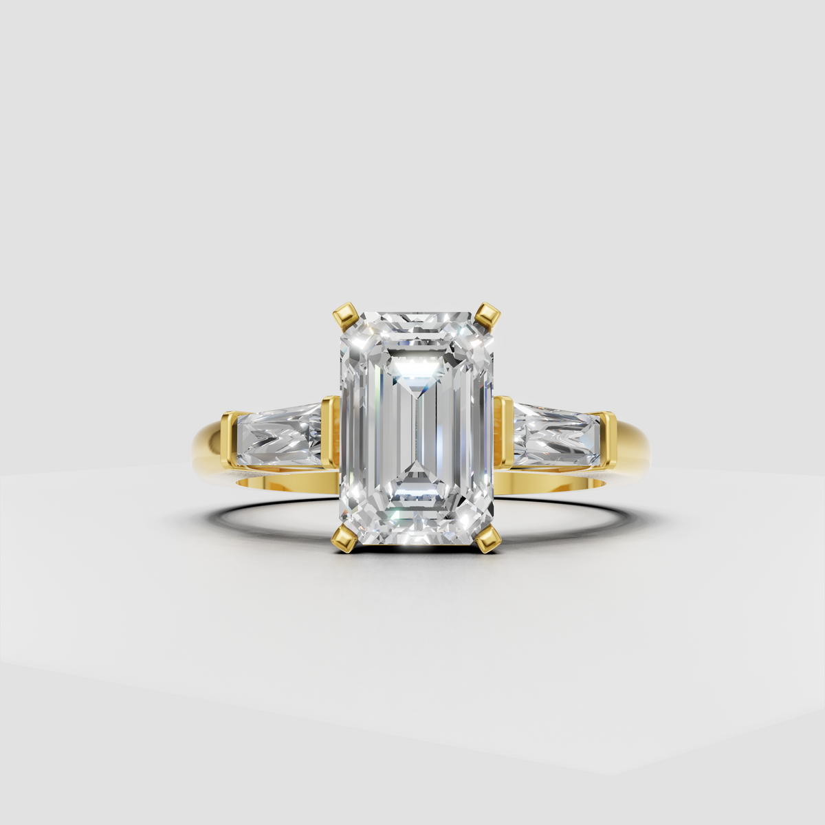 Yellow gold emerald cut engagement ring with tapered baguette side stones