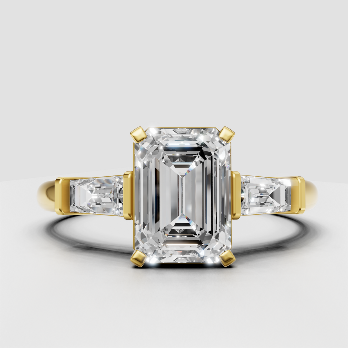 Emerald cut diamond four-prong engagement ring in polished yellow gold